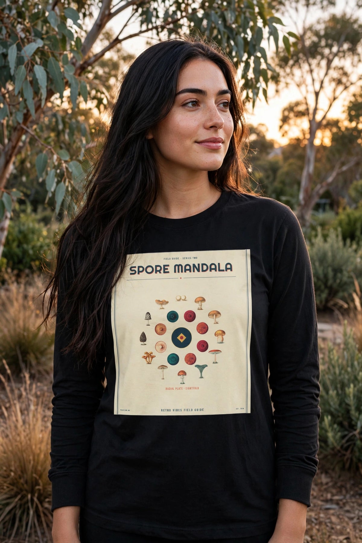 Spore Mandala Long Sleeve Tee in Black worn in a garden at golden hour