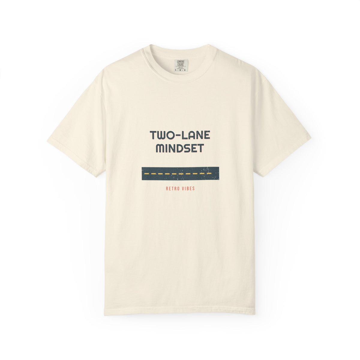 Two-Lane Mindset — stacked highway type over a slate road stripe with a mustard center line, printed on a Comfort Colors 1717 garment-dyed tee by Retro Vibes