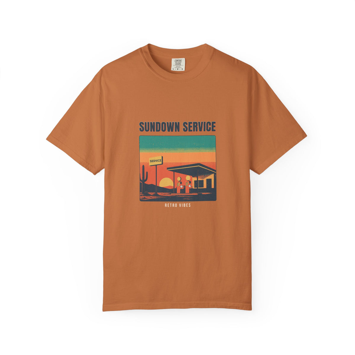 Sundown Service — a roadside service station at dusk: globe pumps, a hand-painted sign, and the sun going down behind the hills, printed on a Comfort Colors 1717 garment-dyed tee by Retro Vibes